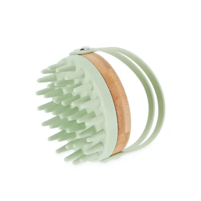 Green massage brush with bamboo handle and flexible hand strap, suitable for coat care or cleaning.