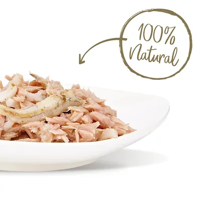 Lautasella paloiteltua lihaa, kuvan yläosassa teksti '100% Natural' englanniksi nuolella osoitettuna ruokaan.