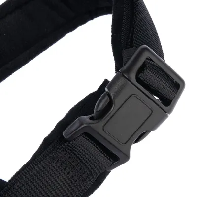 Close-up of a black plastic click fastener on a nylon strap.