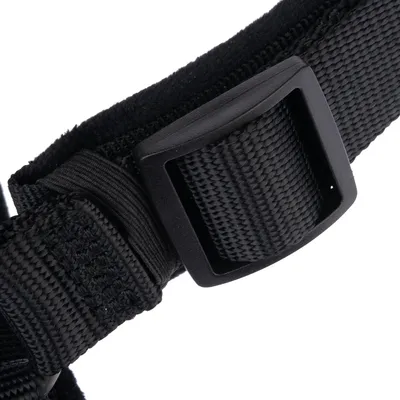 Close-up of a black strap with plastic buckle and woven material.