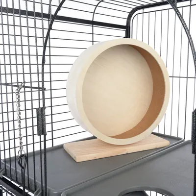 Holzlaufrad mit Kork-Innenfläche, montiert in einem Metallkäfig auf einer Kunststoffplattform.