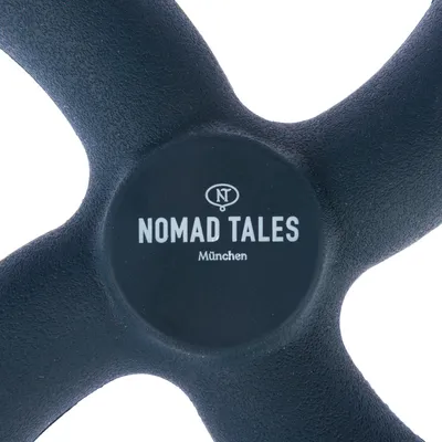 Nomad Tales München. Brand name on a black product with central NT. logo.