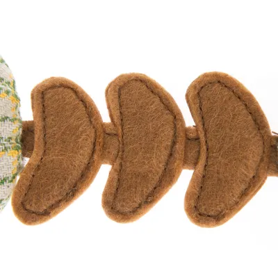 Close-up view of a brown felt toy with segmented elements connected by a fabric seam.