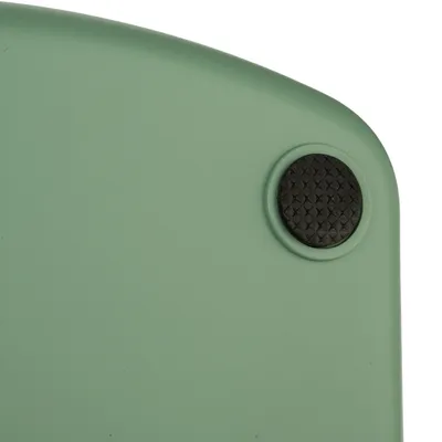 Green plastic surface with black non-slip rubber foot in the corner.