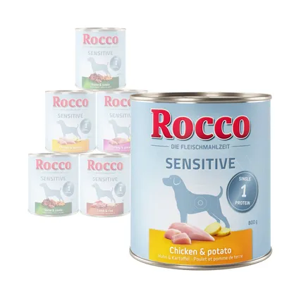 Rocco Sensitive wet food cans in various flavours including chicken and potato, turkey and potato, game and pasta, lamb and rice. Label shows single protein source.