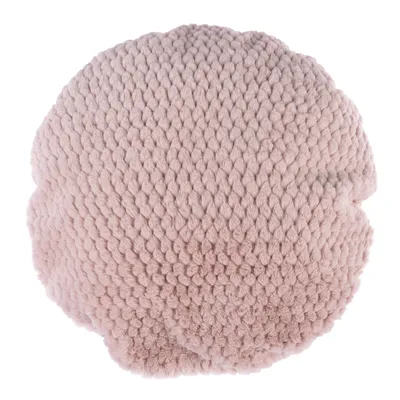 Coussin rond en tissu tricoté rose pâle, texture épaisse et moelleuse visible, sans marque ni texte apparent.