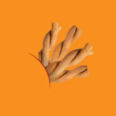Twisted baked treats with a crunchy texture shown against an orange background, partially emerging from a circular cut-out.