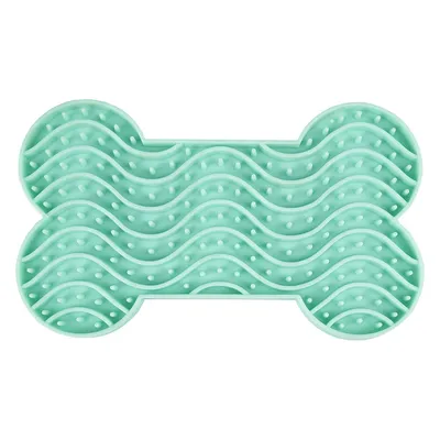 Grön silikonmatta i benform med vågformad struktur och små knoppar, lämplig för långsam ätning eller sysselsättning.