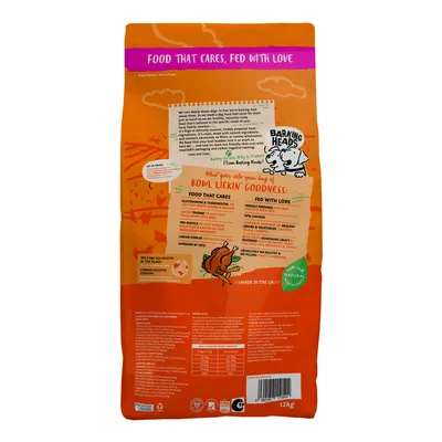 Back of pet food bag showing features such as glucosamine, prebiotics, large kibbles, 50% chicken, no nasties or fillers, feeding guide table, and made in the UK.