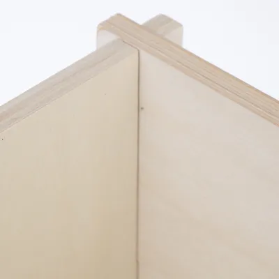 Close-up view of a wood joint made of light plywood with a smooth surface.