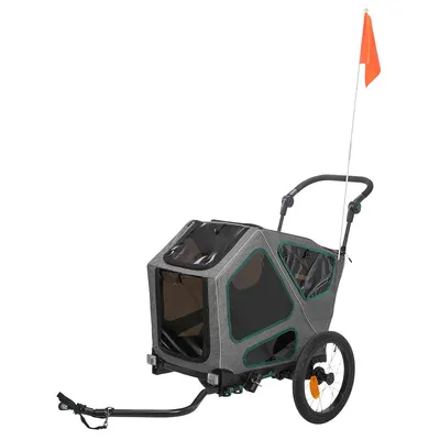 Grauer Fahrradanhänger mit zwei Rädern, schwarzem Griff und orangefarbener Sicherheitsflagge. Sichtfenster an den Seiten und vorne.