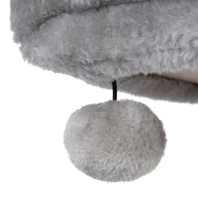 Grauer Plüschball an einer schwarzen Schnur, Detailaufnahme eines Spielzeugs oder Zubehörs mit weicher Oberfläche.