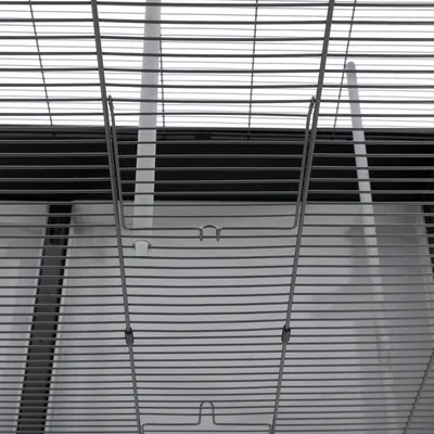 Close-up view of a metal wire cage with horizontal and vertical bars, suitable for small animals. Visible hooks for attachment.