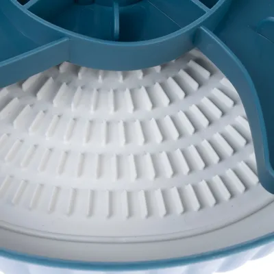 Közelkép egy fehér, bordázott betétről egy kék műanyag tálban. A termék szerkezetét és formáját mutatja.