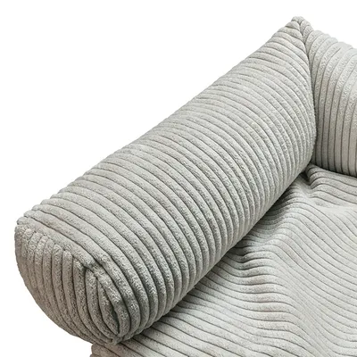 Close-up of a light grey, ribbed fabric cover with soft padding.