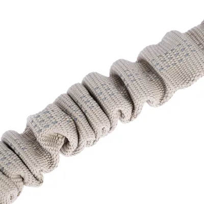 Gros plan sur une sangle beige en tissu avec des points bleus, aspect plissé. Aucun logo ni texte visible.