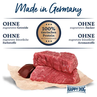Made in Germany. Ohne zugesetztes Getreide, Zucker, künstliche Farbstoffe und Aromastoffe. 100% tierisches Protein am Gesamtprotein. Happy Dog Logo sichtbar.
