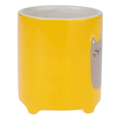 Gamelle en céramique jaune avec motif de tête de chat gris sur le côté, intérieur blanc visible.