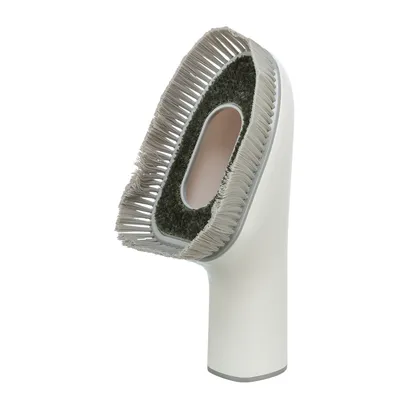 Cepillo blanco con cerdas grises y superficie de fieltro, adecuado para limpiar o cuidar superficies.