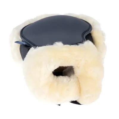 Harnais pour animal avec rembourrage en fausse fourrure beige et partie supérieure noire en similicuir, ouverture centrale visible.