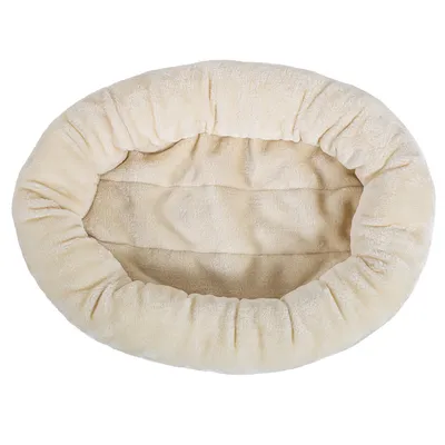 Oval-shaped, cream-coloured plush pet bed with raised padded sides and a soft inner surface, shown from above.