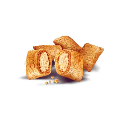 Image shows several crunchy, pillow-shaped filled treats with a visible creamy filling and some crumbs in front.