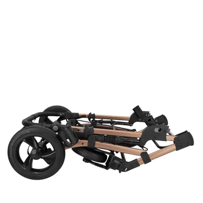Zusammengeklappter Rahmen eines Tiertransportwagens mit schwarzen Rädern und bronzefarbenen Metallstreben.