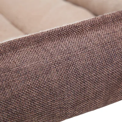 Detail van een huisdierenbed met zichtbare bruine stof en beige gewatteerde binnenkant. Materiaal: textiel.