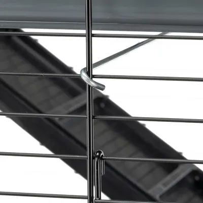 Close-up of a metal cage with hook lock and black plastic tray in the background.