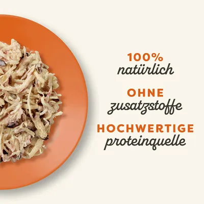 100% natürlich, ohne Zusatzstoffe, hochwertige Proteinquelle. Abgebildet ist zerkleinertes Fleisch auf einem orangefarbenen Teller.