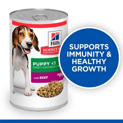 Hill's Science Plan Puppy <1 with Beef konzerv kutyáknak, felirat: SUPPORTS IMMUNITY & HEALTHY GROWTH. Kutya képe és táp látható a csomagoláson.