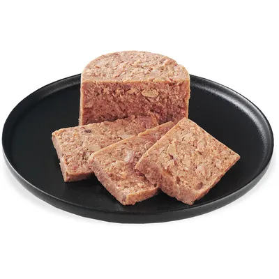 Slices of wet food on a black plate, showing the texture and composition of the food.