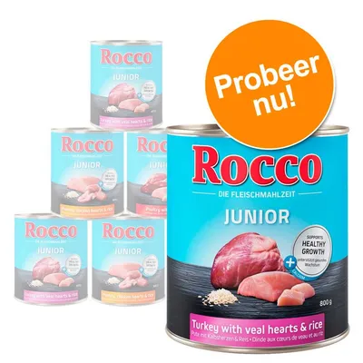 Rocco Junior natvoer, blik van 800 g. Variant: Turkey with veal hearts & rice. Opdruk: 'Supports healthy growth', 'Probeer nu!'. Vlees en rijst zichtbaar op verpakking.
