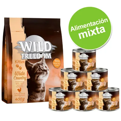 Wild Freedom Kitten Wide Country, embalagem de 400 g e seis latas. Texto visível: '100% grain-free recipe', 'Alimentación mixta' (em espanhol). Imagem de um gato na embalagem.