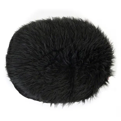 Round, black cushion with fluffy surface, suitable as a lying area or decoration.