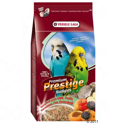 Опаковка Versele-Laga Premium Prestige Budgies с изображение на две вълнисти папагалчета, плодове и семена. Видим текст: 100% Energy & Vitality, Enriched with VAM, Fruits, Chia, Oystershells.