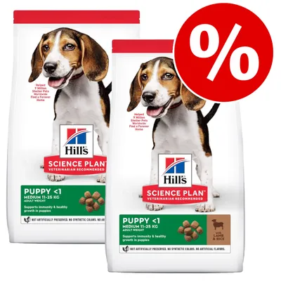 Hill's Science Plan Puppy <1 Medium 11–25 kg, lammas & riisi -koiranruokapakkaus, kaksi pussia ja alennusprosenttimerkki näkyvissä.