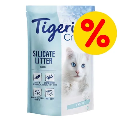 Tigerino Crystals Silicate Litter Classic Sensitive 5L. Texto visible: light & economical, stops odours, inhibits bacterial growth, dust-free. Símbolo de porcentaje en rojo y amarillo.