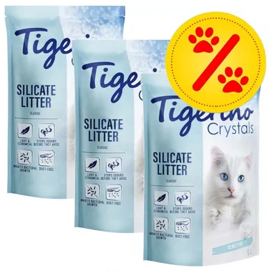 Tigerino Crystals Silicate Litter Classic, 3 Beutel mit Symbolen: leicht, geruchshemmend, hemmt Bakterienwachstum, staubfrei. Gelbes Prozentzeichen mit roten Pfoten.