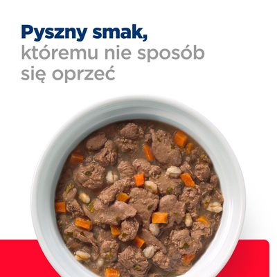 Miska z mokrą karmą dla zwierząt, widoczne kawałki mięsa, marchewki i ziaren. Tekst: Pyszny smak, któremu nie sposób się oprzeć.