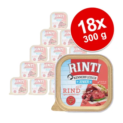 Pachet 18 x 300 g Rinti Kennerfleisch Junior mit Rind, imagine cu cutii pătrate de hrană umedă, text vizibil: 'Reich an Omega3', 'getreidefrei'.