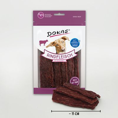 Dokas Rindfleisch gedroogd, verpakking met zichtbare rundersticks, tekst: 100% aus Rind, ca. 11 cm lang. Tekst op verpakking in het Duits.