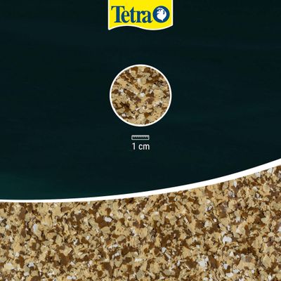 Tetra flake food in close-up, scale shows 1 cm for size reference of the flakes.