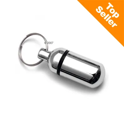 Porte-clés capsule métallique avec joint noir, texte en anglais « Top Seller » sur fond orange dans le coin supérieur droit.