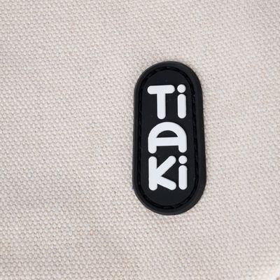 Tiaki. Brand for pet products, logo on beige fabric background.