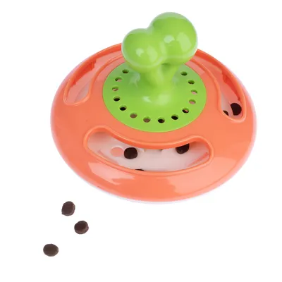 Round orange-green toy with openings, from which small brown treats fall out.
