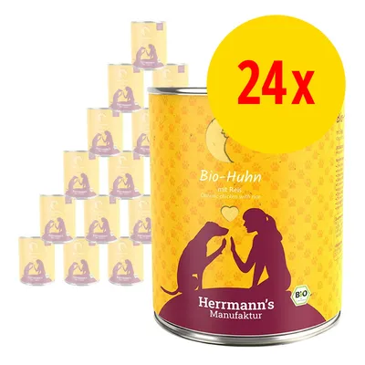 Lot de 24 boîtes Herrmann's Manufaktur Bio-Huhn mit Reis, texte en allemand et anglais sur l’étiquette, logo bio visible. Illustration chien et personne sur chaque boîte.