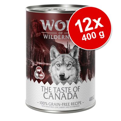 Wolf of Wilderness The Taste of Canada, 12x400 g, spannmålsfri, med nötkött, torsk, kalkon och tranbär. Text: 100% grain-free recipe. Synlig burkförpackning.