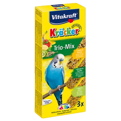 Vitakraft Kräcker Trio-Mix para periquitos, 3 barritas: sésamo y plátano, hierbas y pimentón, kiwi y cítricos. Texto visible en alemán, inglés e italiano.