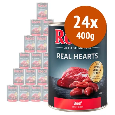 24 lattine da 400 g di Rocco Real Hearts Beef, visibile scritta 'with whole chicken hearts', immagine di carne e cuori su etichetta. Testo in inglese e tedesco.